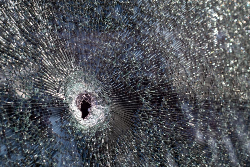 Bullet hole in a windshield.