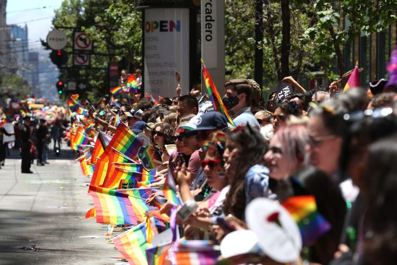 Parade goers hold Pride flags as they line the route of the 52nd Annual San Francisco Pride Parade and Celebration on June 26, 2022 in San Francisco, California.