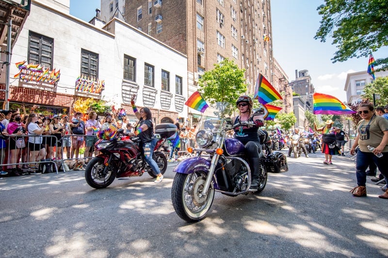 People attend and march in front of the Stonewall Inn at the 2022 Pride March