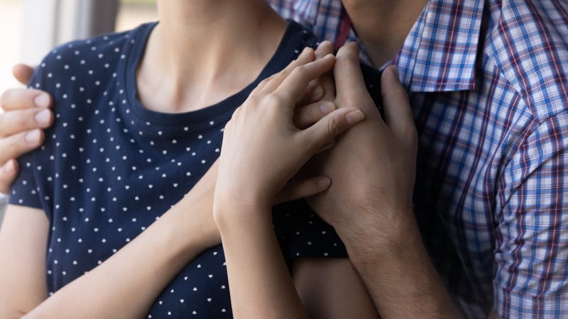 Closeup of young couple holding each other's hands