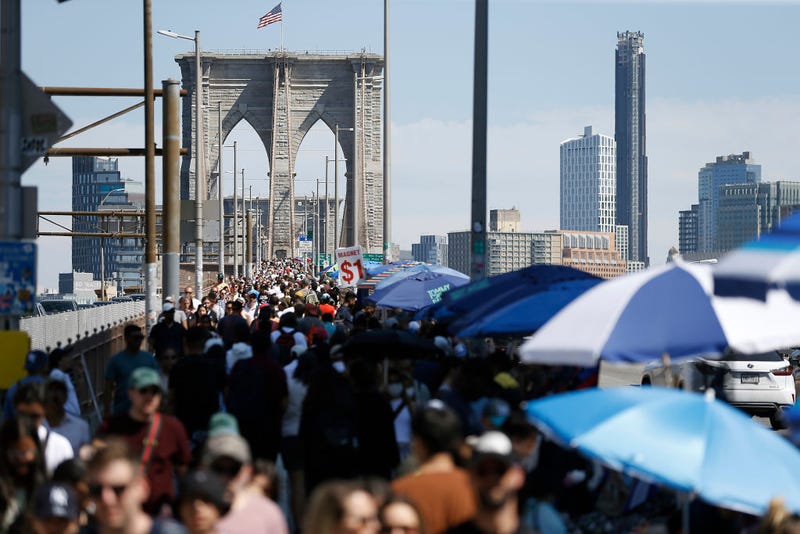 Visitors walk past Brooklyn Bridge vendors on July 3, 2022.