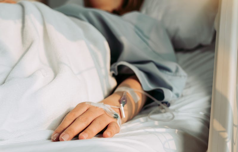 Woman lying sick in hospital.