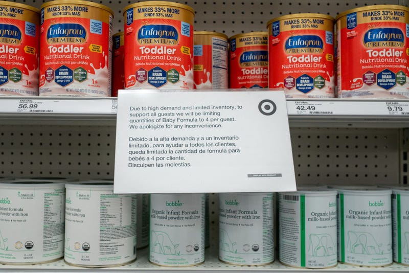 A sign informing customers of limited baby formula is seen on a shelf in a Target store.