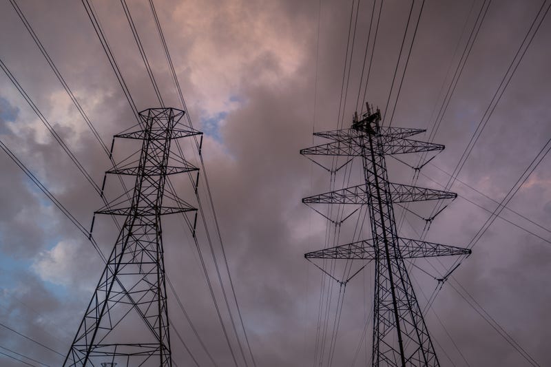 FILE: Transmission towers are seen at the CenterPoint Energy power plant on July 11, 2022, in Houston, Texas.