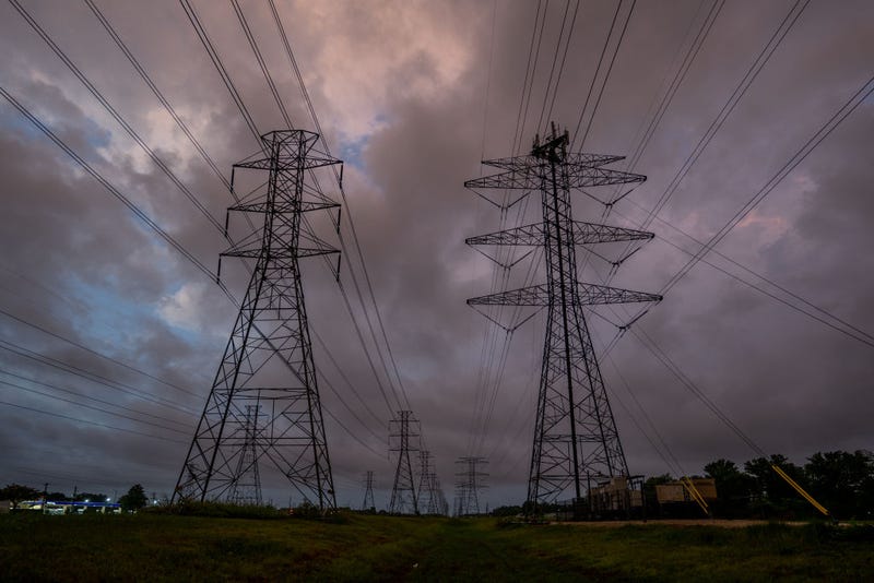 Transmission towers are seen near the CenterPoint Energy power plant on July 11, 2022 in Houston, Texas. ERCOT (Electric Reliability Council of Texas) is urging Texans to voluntarily conserve power today, due to extreme heat potentially causing rolling blackouts.