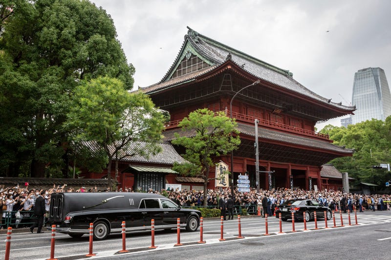 A car carrying the body of former Japanese Prime Minister Shinzo Abe leaves Zojoji temple following his funeral on July 12, 2022 in Tokyo, Japan.