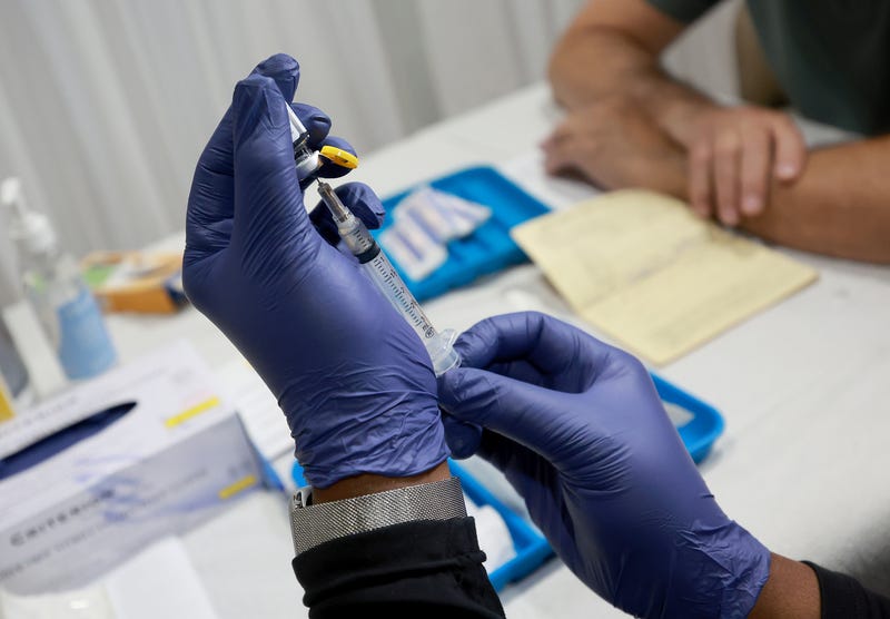 A healthcare worker prepares to administer a vaccine to a person for the prevention of monkeypox the Pride Center on July 12, 2022 in Wilton Manors, Florida.