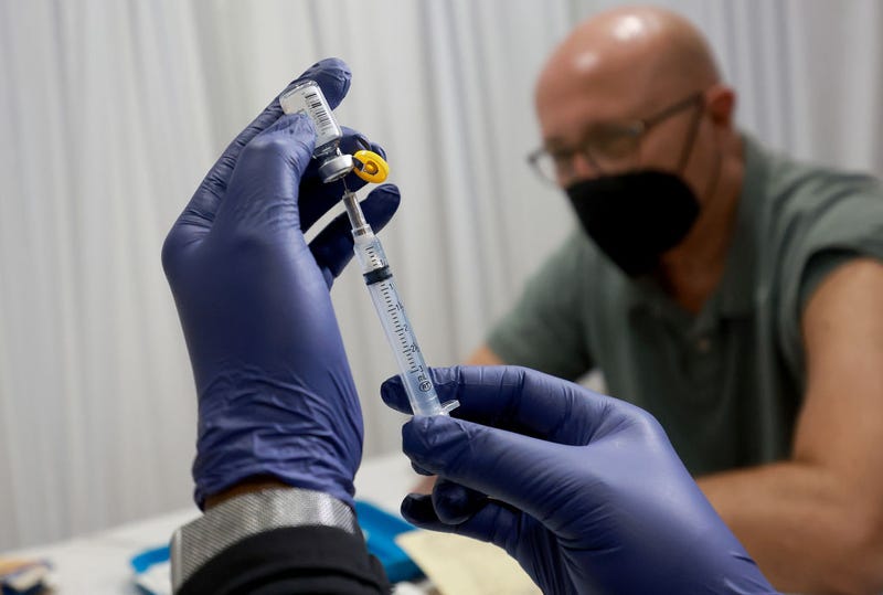 A healthcare worker prepares to administer a vaccine to Michael Nicot for the prevention of monkeypox the Pride Center on July 12, 2022 in Wilton Manors, Florida.