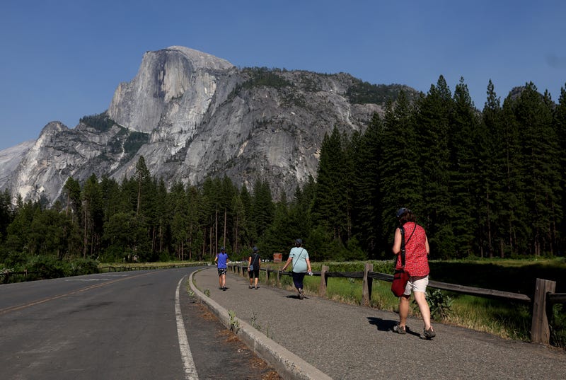 Yosemite National Park visitors walk near Half Dome on July 12, 2022 in Yosemite Ntl Park, California.