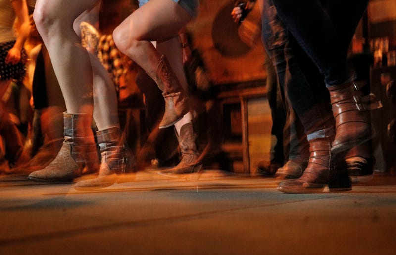 Patrons dance during weekly line dancing lessons at a bar in San Francisco, Calif.