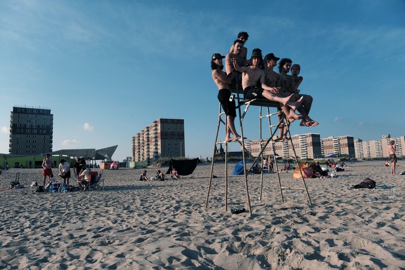 People enjoy a warm evening at Rockaway Beach on July 19, 2022 in New York City
