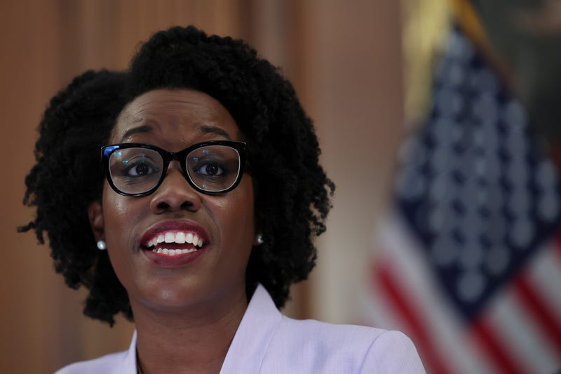 Lauren Underwood speaks with an American Flag in the background