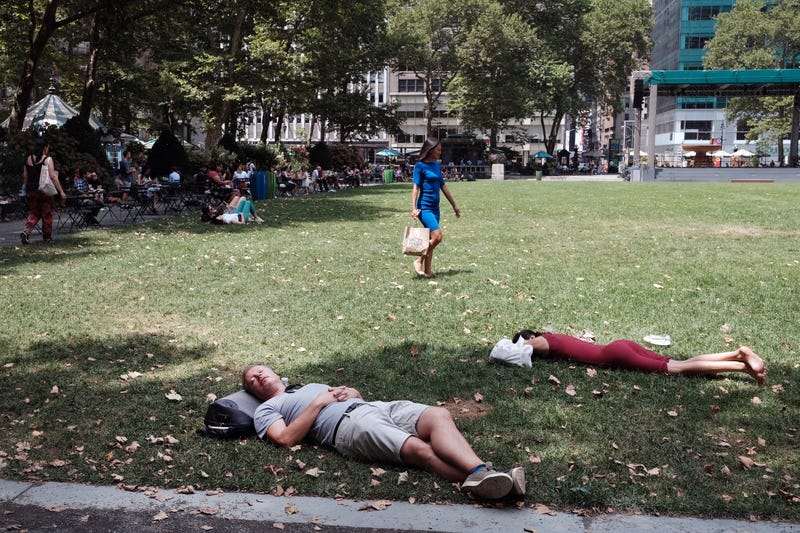 People rest in the shade in Bryant Park in midtown Manhattan as temperatures reach into the 90s on July 21, 2022 in New York City