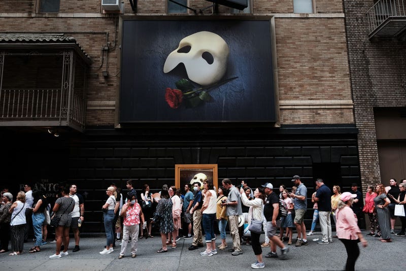 People wait in line to see Phantom of the Opera in midtown Manhattan as temperatures reach into the 90s on July 21, 2022 in New York City.
