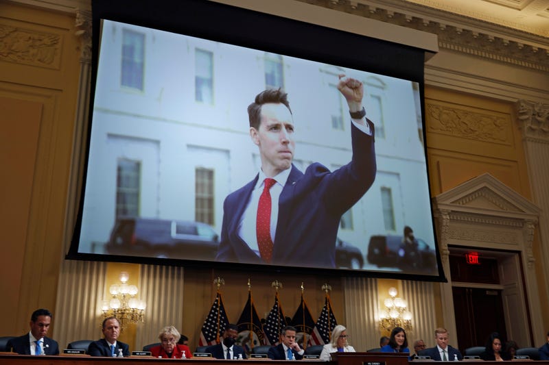 A photograph of Sen. Josh Hawley (R-MO) pumping his fist toward the rioters on January 6, 2021 is shown during a prime-time hearing of the House Select Committee to Investigate the attack on the U.S. Capitol the Cannon House Office Building on July 21, 2022 in Washington, DC.