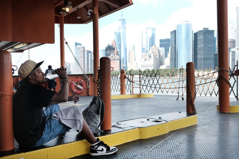 A man takes a drink of water while riding on the Staten Island Ferry on a sweltering afternoon as temperatures reach into the 90s on July 21, 2022 in New York City