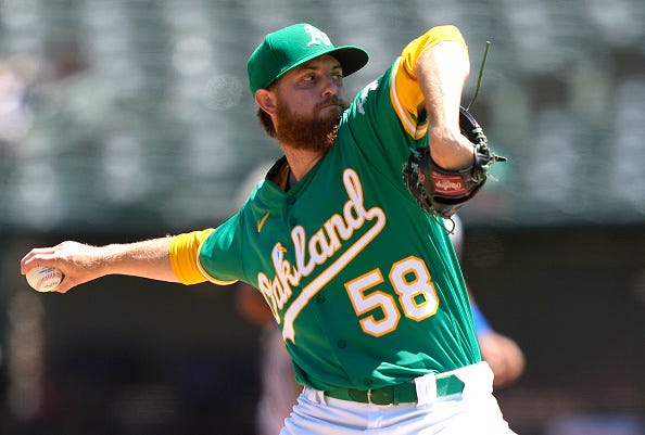 Paul Blackburn models the A's Kelly green alternate tops.
