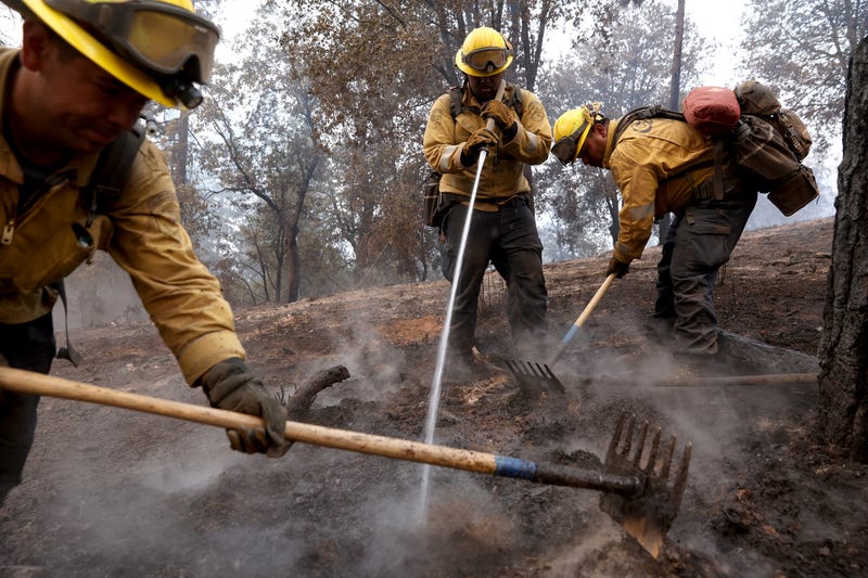 Cal Fire firefighters mop up hot spots after the Oak Fire moved through the area on July 25, 2022 near Jerseydale, California.