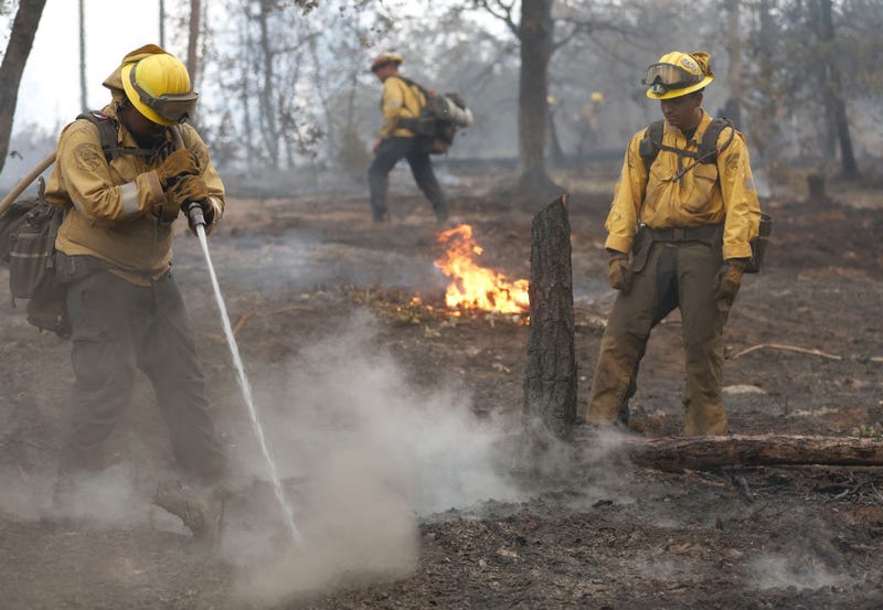 Cal Fire firefighters mop up hot spots after the Oak Fire moved through the area on July 25, 2022 near Jerseydale, California.