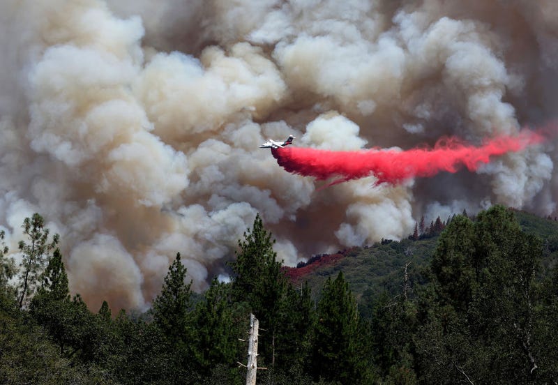 A firefighting aircraft drops retardant ahead of the Oak Fire on July 24, 2022 near Jerseydale, California.