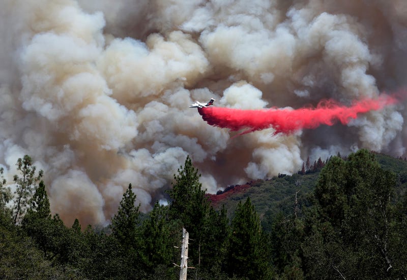 A firefighting aircraft drops retardant ahead of the Oak Fire on July 24, 2022 near Jerseydale, California.
