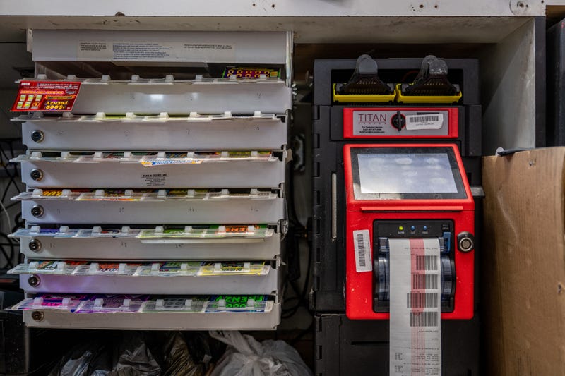 A shelf holding lottery tickets is seen behind a Chevron gas station countertop on July 28, 2022, in Houston City, Texas.