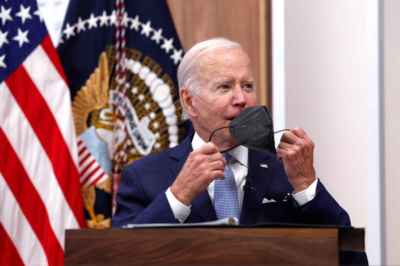 President Joe Biden taking a mask off