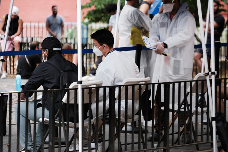 Healthcare workers with New York City Department of Health and Mental Hygiene work at intake tents where individuals are registered to receive the monkeypox vaccine on July 29, 2022 in New York City. The World Health Organization has now declared that the monkeypox outbreak, which continues to grow globally, is a global emergency.