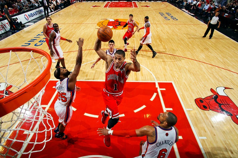 Derrick Rose, of the Chicago Bulls, dunks against Baron Davis and Tyson Chandler, of the New York Knicks, on March 12, 2012 at the United Center in Chicago. As Stacey King famously stated during a different Bulls game: "Derrick Rose can go upstairs."
