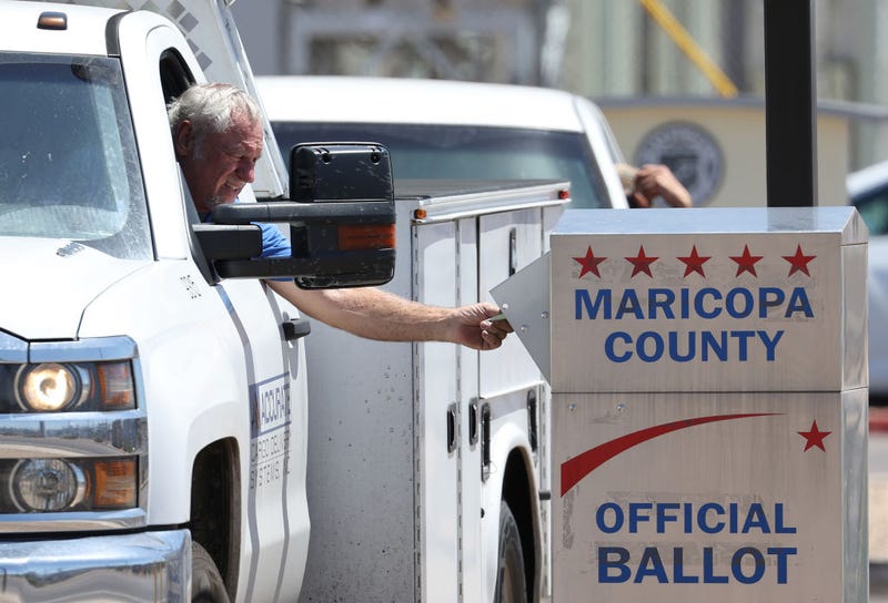 A voter places a ballot in a drop box outside of the Maricopa County Elections Department on August 02, 2022 in Phoenix, Arizona. Arizonans are heading to the polls to vote in the state's midterm primary election. (Photo by Justin Sullivan/Getty Images)