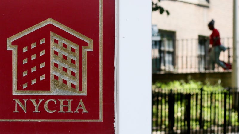 A NYCHA sign is displayed at a housing development in the city