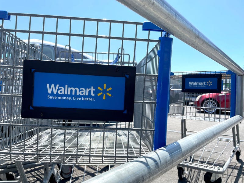 Shopping carts sit in the parking lot of a Walmart store