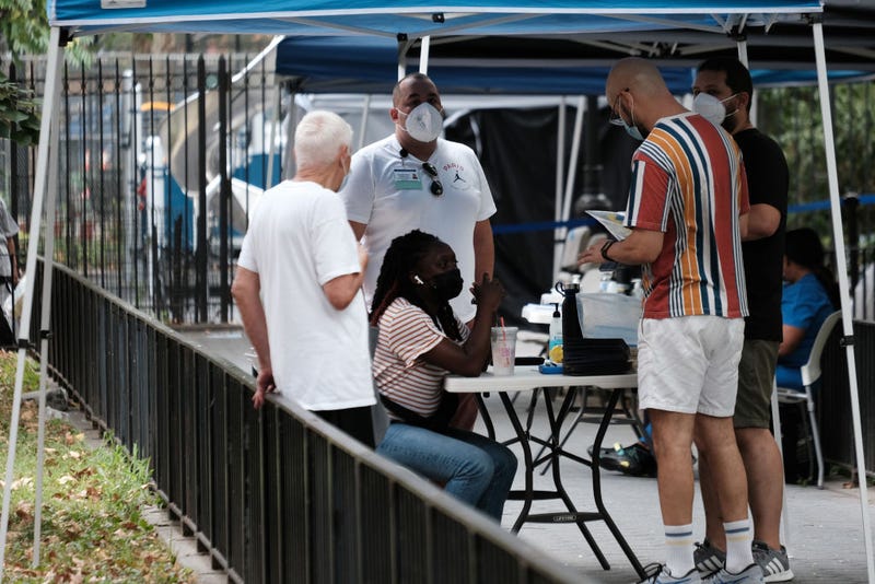 People line up to speak with healthcare workers with New York City Department of Health and Mental Hygiene at intake tents where individuals are registered to receive the monkeypox vaccine on August 5, 2022 in New York City