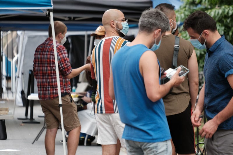 People line up to speak with healthcare workers with New York City Department of Health and Mental Hygiene at intake tents where individuals are registered to receive the monkeypox vaccine on August 5, 2022 in New York City. 