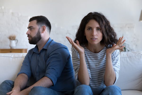 Couple sitting on the couch having an argument