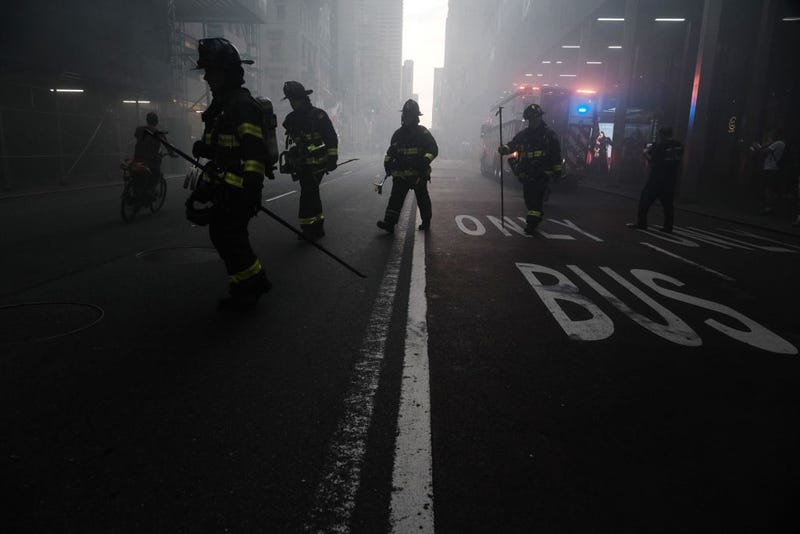Firefighters respond as smoke engulfs Fifth Avenue, blocks away from Trump Tower, as a fire breaks out in a building under construction on August 09, 2022 in New York City.