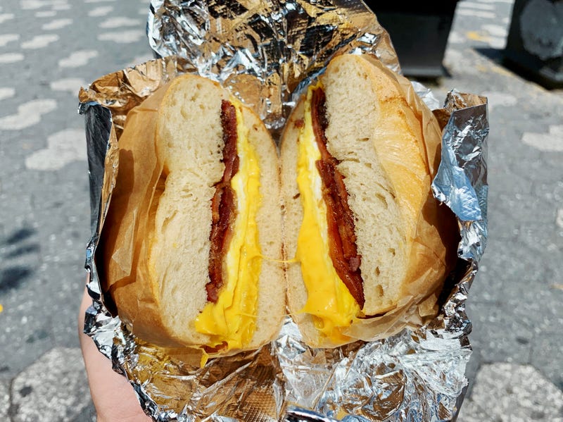A bacon, egg, and cheese sandwich—or BEC—made on a fluffy plain bagel from a local New York City bagel shop in Brooklyn, New York.
