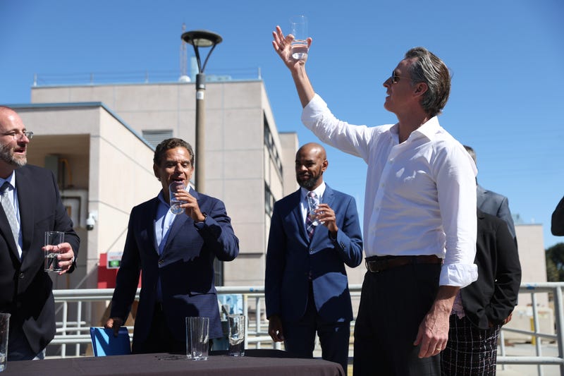 California Gov. Gavin Newsom (R) prepares to taste wastewater that was treated at the Antioch Water Treatment Plant with former Los Angeles Mayor Antonio Villaraigosa (L) and Antioch Mayor Lamar Thorpe (C) on August 11, 2022 in Antioch, California.