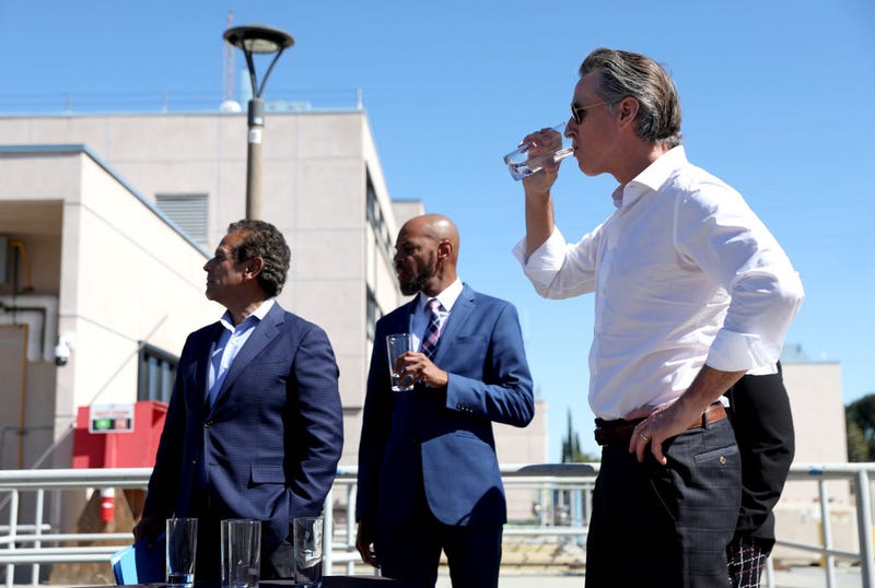 California Gov. Gavin Newsom (R) tastes recycled water that was treated at the Antioch Water Treatment Plant with Antioch Mayor Lamar Thorpe (C) and former Los Angeles Mayor and newly appointed California infrastructure czar Antonio Villaraigosa on August 11, 2022 in Antioch, California.