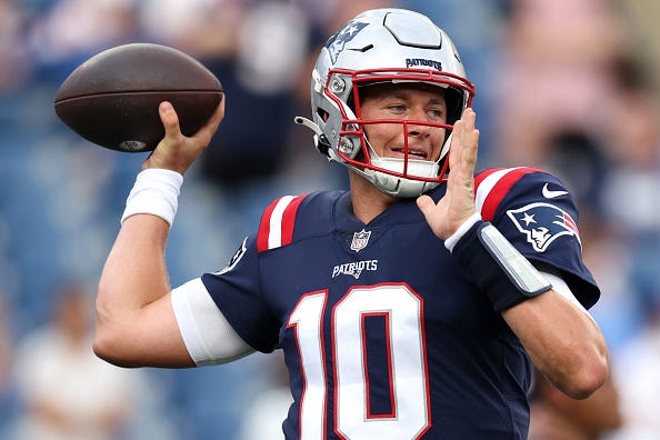 Mac Jones models the Patriots navy blue jerseys. 