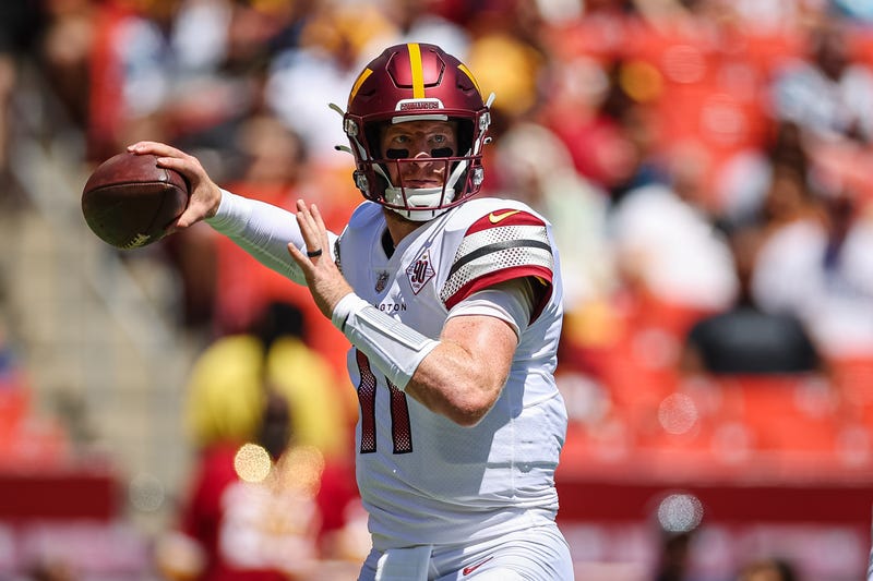 Washington Commanders quarterback Carson Wentz prepares to pass against the Carolina Panthers in a 2022 preseason game.