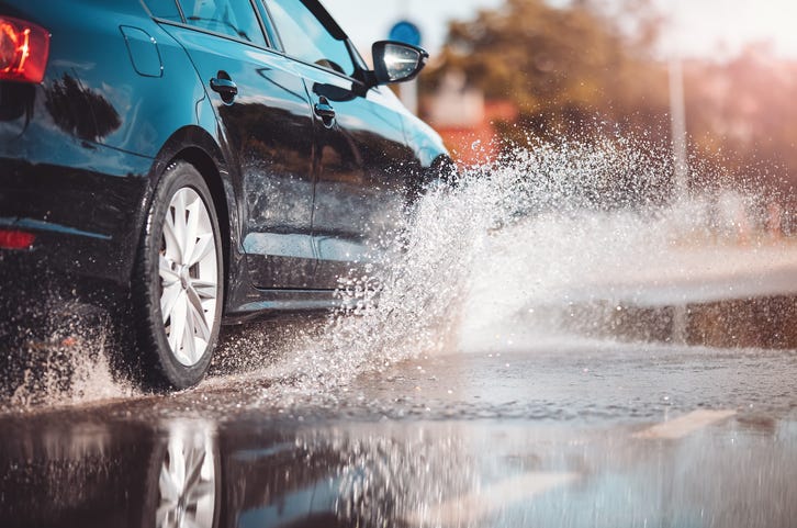 car driving through puddle