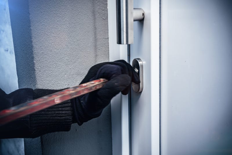 Masked burglars breaking and entering into a victim's home.