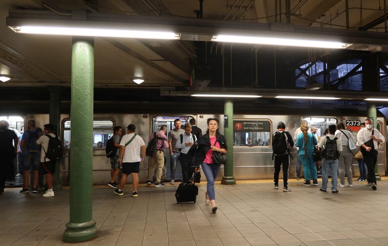 People wait to board a 1 subway train at the Columbus Circle - 59th Street station.  