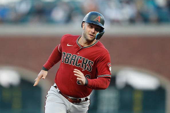 Christian Walker models the sedona red alternate tops of the Diamondbacks.