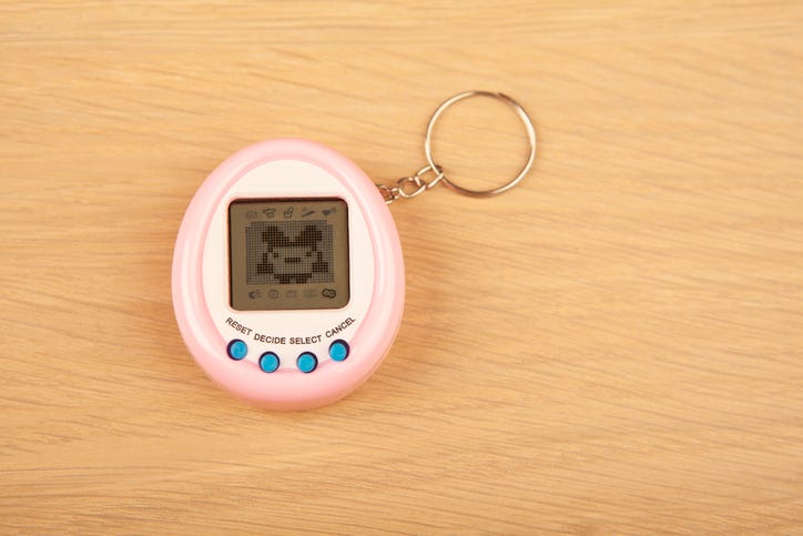 Tamagotchi toy on a desk. 