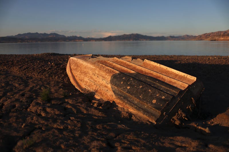 A previously sunken boat sits on the banks of Lake Mead on August 19, 2022 in Lake Mead National Recreation Area, Nevada. The boat belongs to Steve Buckalew, who said it crashed and sank during a water skiing competition in 1977.
