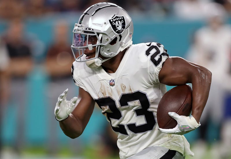 : Kenyan Drake #23 of the Las Vegas Raiders rushes during the second quarter against the Miami Dolphins at Hard Rock Stadium on August 20, 2022 in Miami Gardens, Florida.