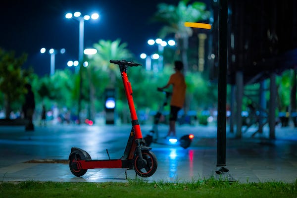 Electric scooter rider at night