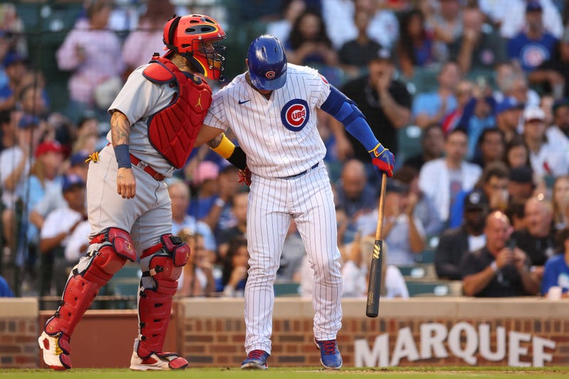 CHICAGO, ILLINOIS - AUGUST 22: Willson Contreras #40 of the Chicago Cubs greets Yadier Molina #4 of the St. Louis Cardinals during the first inning at Wrigley Field on August 22, 2022 in Chicago, Illinois.